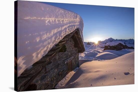 The Last Rays of Sun Light Up the Prabello Alp Chalets Covered with Snow-ClickAlps-Stretched Canvas