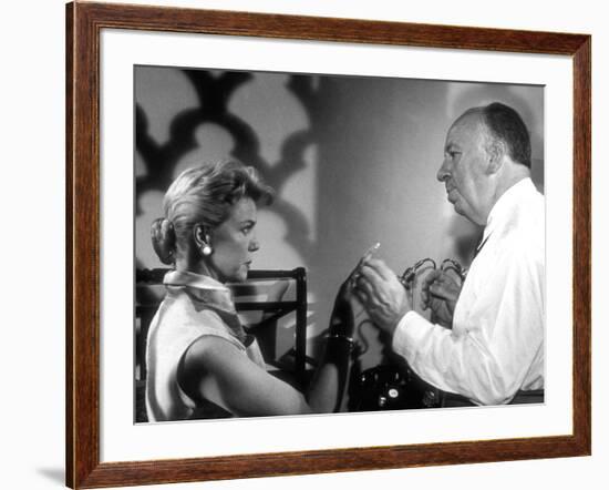 THE MAN WHO KNEW TOO MUCH, 1956 On the set, Alfred Hitchcock directs Doris Day (b/w photo)-null-Framed Photo