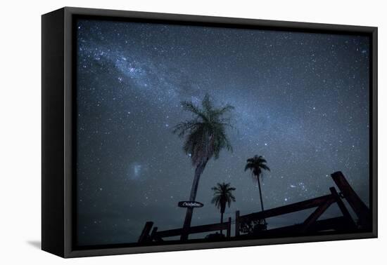 The Milky Way Above Palm Trees and a Wooden Farm Gate-Alex Saberi-Framed Stretched Canvas