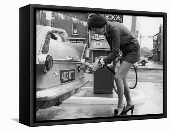 The Modern Female Petrol Pump Operator Refuelling a Car in Her Mini Skirt-null-Framed Stretched Canvas