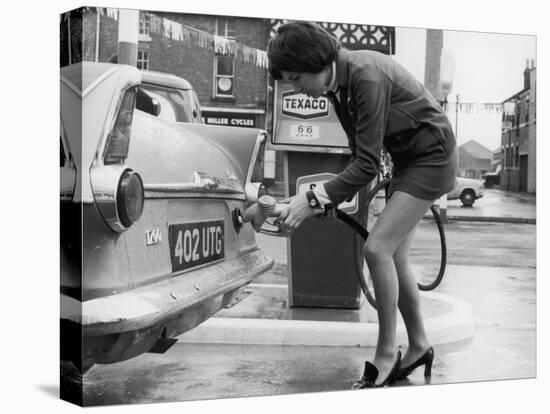 The Modern Female Petrol Pump Operator Refuelling a Car in Her Mini Skirt-null-Stretched Canvas