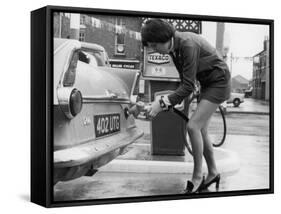 The Modern Female Petrol Pump Operator Refuelling a Car in Her Mini Skirt-null-Framed Stretched Canvas