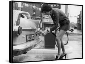 The Modern Female Petrol Pump Operator Refuelling a Car in Her Mini Skirt-null-Framed Stretched Canvas