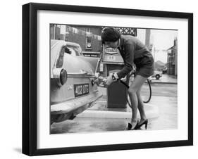 The Modern Female Petrol Pump Operator Refuelling a Car in Her Mini Skirt-null-Framed Premium Photographic Print