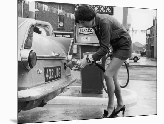 The Modern Female Petrol Pump Operator Refuelling a Car in Her Mini Skirt-null-Mounted Photographic Print