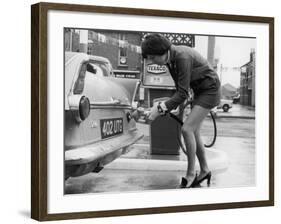 The Modern Female Petrol Pump Operator Refuelling a Car in Her Mini Skirt-null-Framed Photographic Print