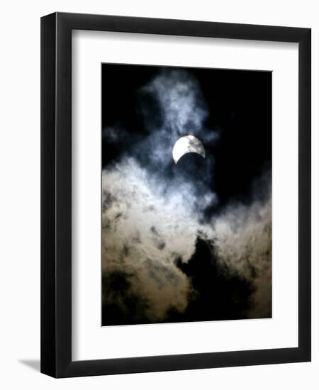 The Moon Partially Covers the Sun Behind the Clouds During a Partial Solar Eclipse-null-Framed Premium Photographic Print