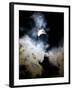 The Moon Partially Covers the Sun Behind the Clouds During a Partial Solar Eclipse-null-Framed Photographic Print