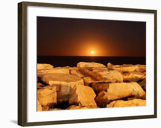 The Moon Rising Behind Rocks Lit by a Nearby Fire in Miramar, Argentina-Stocktrek Images-Framed Photographic Print