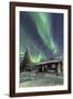 The Northern Lights (Aurora borealis) frame the wooden hut in the snowy woods, Pallas, Yllastunturi-Roberto Moiola-Framed Photographic Print