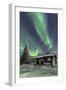 The Northern Lights (Aurora borealis) frame the wooden hut in the snowy woods, Pallas, Yllastunturi-Roberto Moiola-Framed Photographic Print