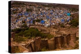 The Palace Walls of Mehrangarh Fort Towering over the Blue Rooftops in Jodhpur, the Blue City-Laura Grier-Stretched Canvas