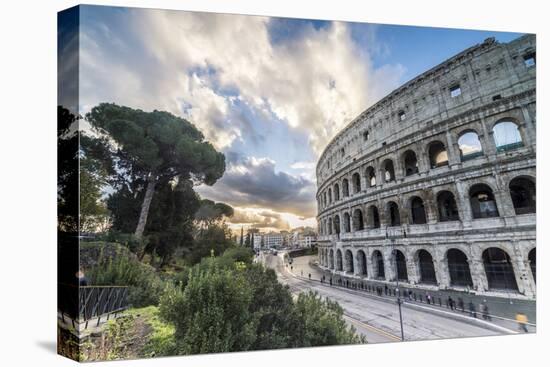 The pink sky at sunrise frames the ancient Colosseum (Flavian Amphitheatre), UNESCO World Heritage -Roberto Moiola-Stretched Canvas