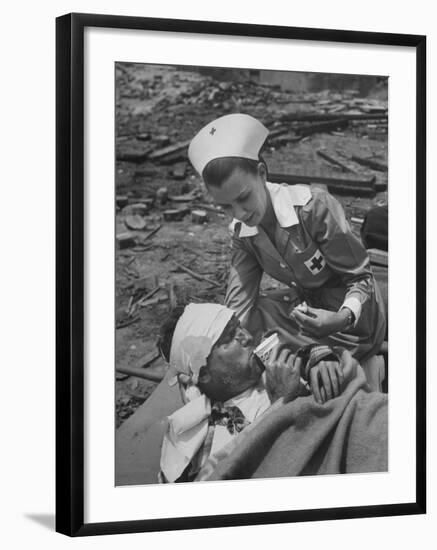 The Red Cross Nurse Trying to Help the Injured Man Eat and Drink-Allan Grant-Framed Photographic Print