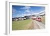 The red train runs across the alpine village of Zuoz in spring, Maloja, Canton of Graubunden, Engad-Roberto Moiola-Framed Photographic Print