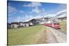 The red train runs across the alpine village of Zuoz in spring, Maloja, Canton of Graubunden, Engad-Roberto Moiola-Stretched Canvas