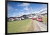 The red train runs across the alpine village of Zuoz in spring, Maloja, Canton of Graubunden, Engad-Roberto Moiola-Framed Photographic Print