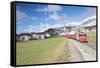 The red train runs across the alpine village of Zuoz in spring, Maloja, Canton of Graubunden, Engad-Roberto Moiola-Framed Stretched Canvas