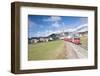 The red train runs across the alpine village of Zuoz in spring, Maloja, Canton of Graubunden, Engad-Roberto Moiola-Framed Photographic Print