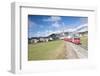 The red train runs across the alpine village of Zuoz in spring, Maloja, Canton of Graubunden, Engad-Roberto Moiola-Framed Photographic Print