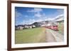 The red train runs across the alpine village of Zuoz in spring, Maloja, Canton of Graubunden, Engad-Roberto Moiola-Framed Photographic Print