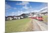 The red train runs across the alpine village of Zuoz in spring, Maloja, Canton of Graubunden, Engad-Roberto Moiola-Mounted Photographic Print