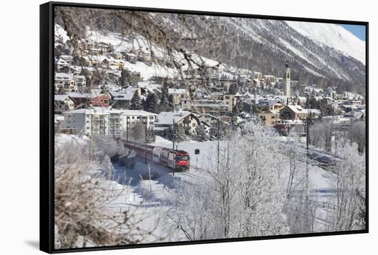 The red train runs across the snowy landscape around Samedan, Maloja, Canton of Graubunden, Engadin-Roberto Moiola-Framed Stretched Canvas