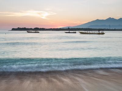 https://imgc.allpostersimages.com/img/posters/the-sea-laps-up-on-the-sand-in-gili-trawangan-at-sunrise_u-L-PINZ160.jpg?artPerspective=n