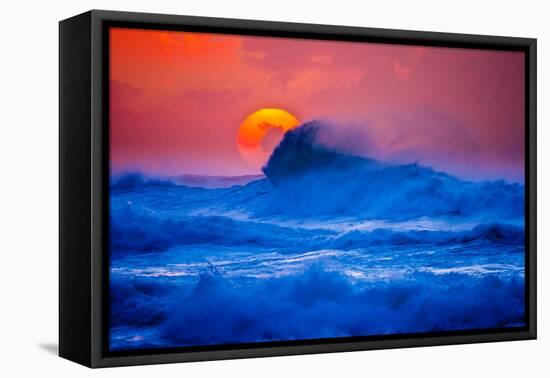 The setting sun and large winter waves breaking off the north coast of Kauai, Hawaii-Mark A Johnson-Framed Stretched Canvas