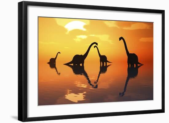 The Silhouetted Shapes of Sauropod Dinosaurs at the Start of a Prehistoric Day-Stocktrek Images-Framed Art Print