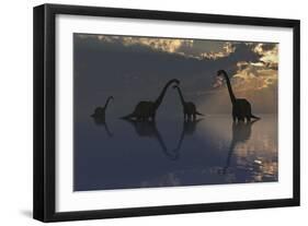 The Silhouetted Shapes of Sauropod Dinosaurs at the Start of a Prehistoric Day-Stocktrek Images-Framed Art Print
