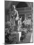 The Statue of Aphrodite and Eros in Louvre Museum During a Flower Show-Dmitri Kessel-Mounted Photographic Print