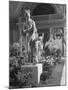 The Statue of Aphrodite and Eros in Louvre Museum During a Flower Show-Dmitri Kessel-Mounted Photographic Print