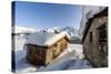 The Sun, Covered with Thin Clouds, Illuminating a Typical Hut Covered with Snow at the Maloja Pass-Roberto Moiola-Stretched Canvas