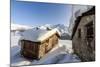 The Sun, Covered with Thin Clouds, Illuminating a Typical Hut Covered with Snow at the Maloja Pass-Roberto Moiola-Mounted Photographic Print