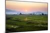 The Sun Sets Behind Foggy Hills and Expansive Rice Paddy Fields Near Chiang Mai, Thailand-Dan Holz-Mounted Photographic Print