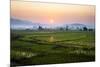 The Sun Sets Behind Foggy Hills and Expansive Rice Paddy Fields Near Chiang Mai, Thailand-Dan Holz-Mounted Photographic Print