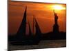 The Sun Sets Behind the Statue of Liberty on the Longest Day of the Year-null-Mounted Premium Photographic Print