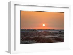 The sun setting over the landscape of hoodoos and hills of Badlands National Park.-Sheila Haddad-Framed Photographic Print