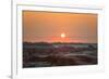 The sun setting over the landscape of hoodoos and hills of Badlands National Park.-Sheila Haddad-Framed Photographic Print