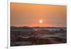 The sun setting over the landscape of hoodoos and hills of Badlands National Park.-Sheila Haddad-Framed Photographic Print