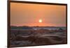 The sun setting over the landscape of hoodoos and hills of Badlands National Park.-Sheila Haddad-Framed Photographic Print