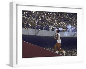 The Torch Being Carried Up the Steps in the Olympic Stadium at the Summer Olympics-John Dominis-Framed Photographic Print