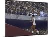 The Torch Being Carried Up the Steps in the Olympic Stadium at the Summer Olympics-John Dominis-Mounted Photographic Print