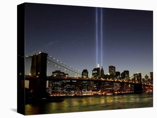 The Tribute of Light Memorial Shines into the Sky Over the Night Skyline of New York City-null-Stretched Canvas