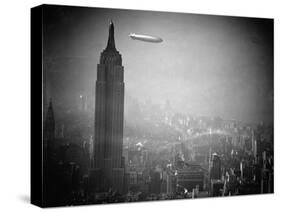 The Zeppelin Hindenburg Floats Past the Empire State Building-null-Stretched Canvas