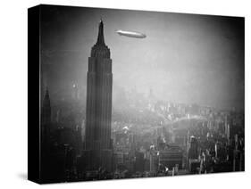 The Zeppelin Hindenburg Floats Past the Empire State Building-null-Stretched Canvas