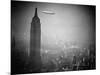 The Zeppelin Hindenburg Floats Past the Empire State Building-null-Mounted Photographic Print