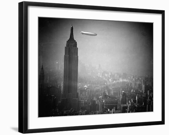 The Zeppelin Hindenburg Floats Past the Empire State Building-null-Framed Photographic Print