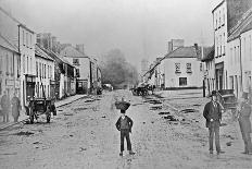 A Young Delivery Boy Stands Nonchalantly in the Main Street of Clonmorris-Thomas Wynne-Giclee Print